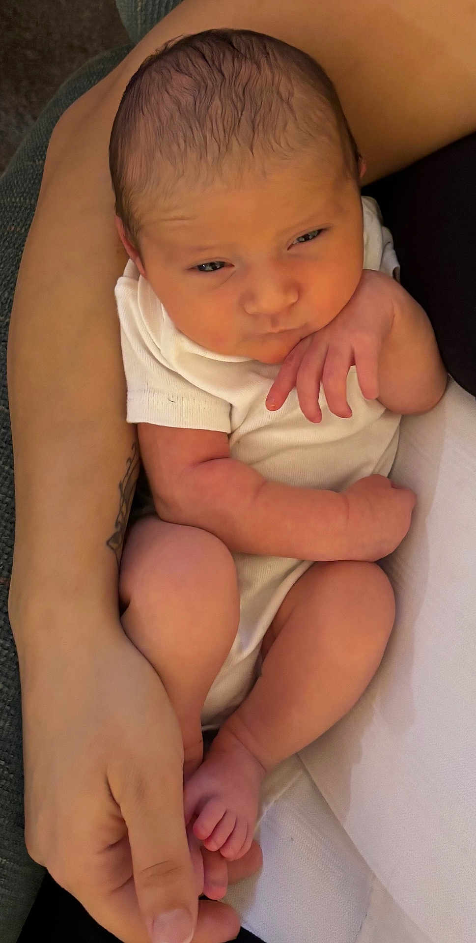 Ava is registered to the contest to win money with this photo: baby, infant, newborn, arm, hand, skin, clothing, white, person, human, face, legs, feet, fingers, resting, holding, cozy, cute, portrait, closeup