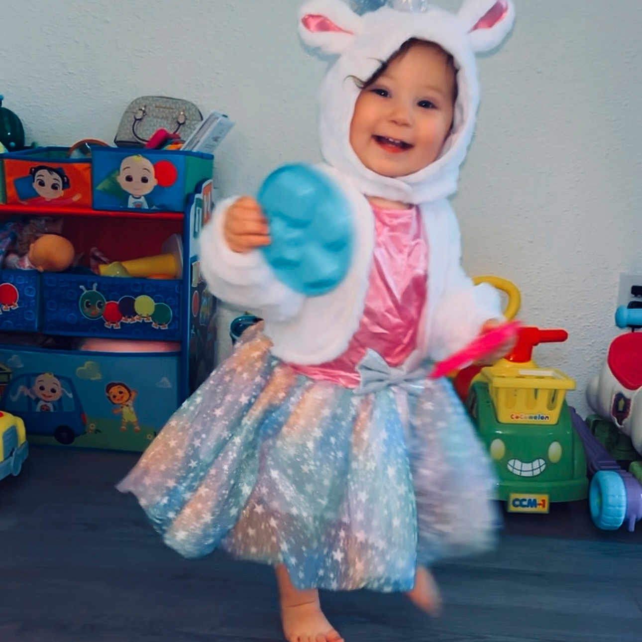 Aniah is registered to the contest to win money with this photo: bodypart, bonnet, car, child, clothing, costume, dress, face, female, finger, girl, hat, head, person, photography, portrait, toy, transportation, vehicle, wood