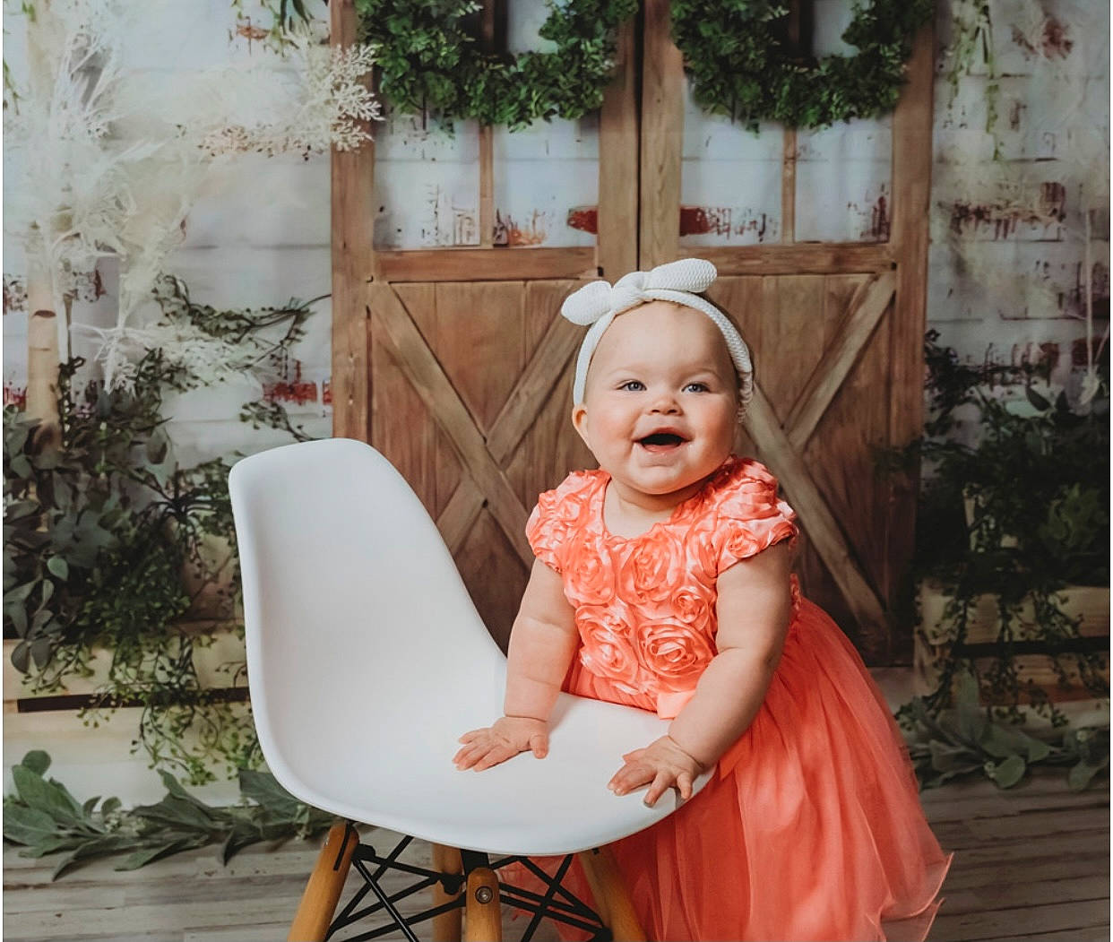 Kaizley is registered to the contest to win money with this photo: baby_toddler_clothing, chair, child, comfort, dress, event, fence, flash_photography, fun, happy, headgear, headpiece, headwear, pattern, peach, person, pink, plant, smile, toddler