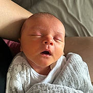 Hudson joined the competition — help win amazing prizes! newborn, baby, sleeping, blanket, swaddled, person, lap, soft, white, gray, clothing, peaceful, infant, face, head, closed_eyes, skin, rest, indoors, comfort