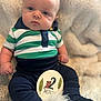 baby, infant, child, striped_shirt, navy_pants, fluffy_blanket, sitting, portrait, cute, 2_months, sign, indoor, soft_lighting, curious_expression, chubby_cheeks, young_child, closeup, face, hands, feet
