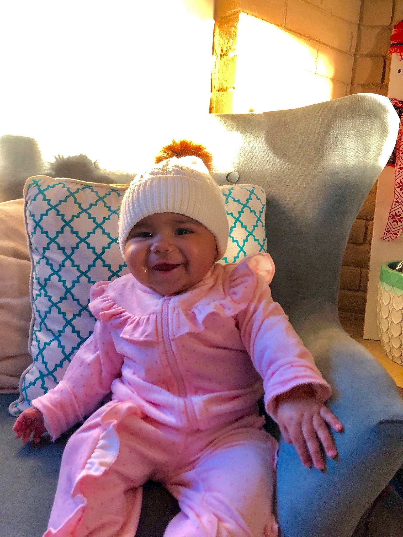 Emry is registered to the contest to win money with this photo: cap, child, day, fun, girl, headgear, headwear, infant, person, pink, product, sitting, skin, smile, textile, toddler