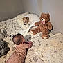 animal, baby, bed, bedroom, bodypart, canine, couch, dog, face, finger, furniture, hand, head, indoors, person, pet, photography, portrait, teddybear, toy