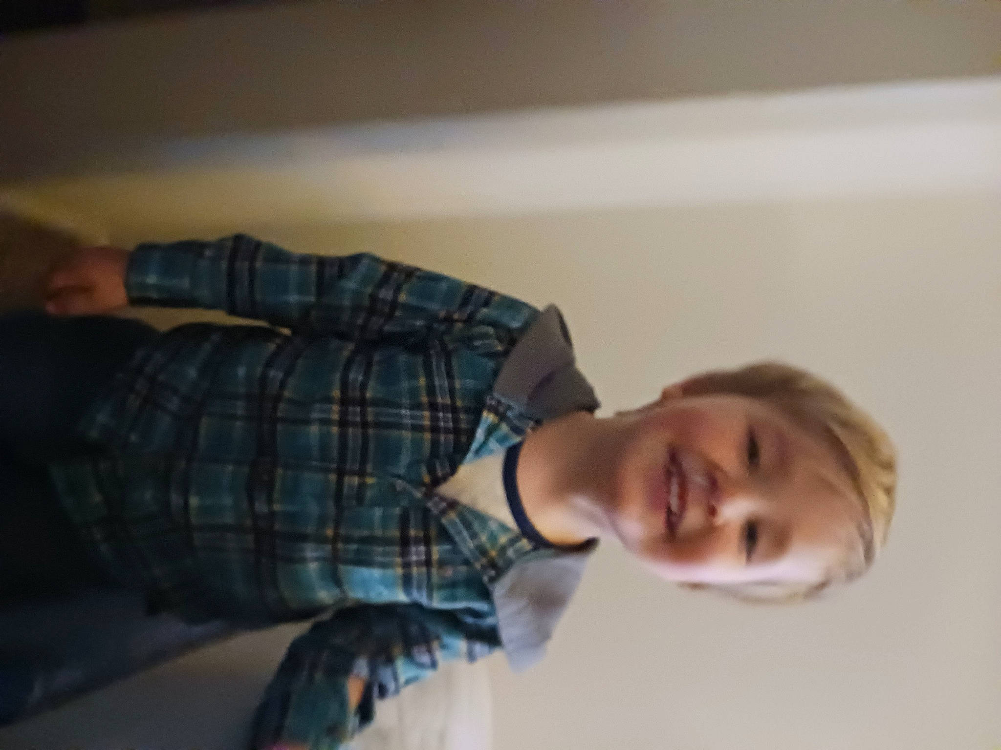 Lucian is registered to the contest to win money with this photo: child, comfort, dress_shirt, elbow, flooring, fun, happy, human_leg, joy, pattern, person, plaid, room, sitting, smile, tartan, wood