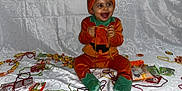 Tenessy participe au concours pour gagner de l'argent avec cette photo : baby, child, costume, pumpkin, orange, green, hat, smile, happy, candy, wrappers, string, sitting, fabric, pattern, playful, celebration, holiday, indoors, portrait