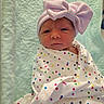 Elizabeth joined the competition — help win amazing prizes! newborn, baby, infant, child, portrait, face, eyes, bow, hat, blanket, swaddle, polka_dot, colorful, pink, white, lying_down, indoors, nursery, soft_lighting, close_up