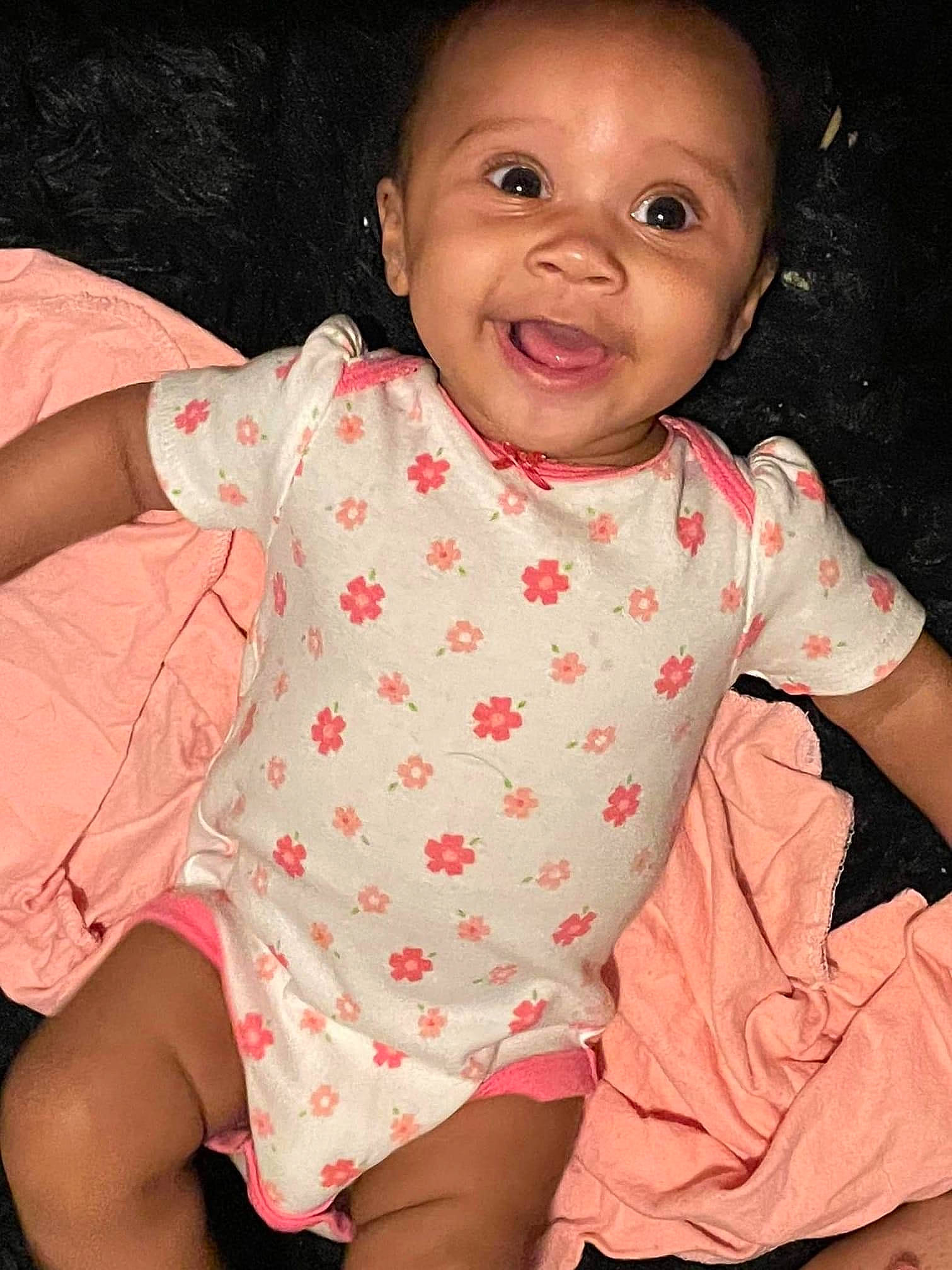 Sariyah joined the competition — help win amazing prizes! arm, baby, baby_toddler_clothing, cheek, chin, collar, finger, hand, happy, human_body, iris, lip, mouth, neck, nose, person, pink, skin, sleeve, smile