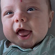 Donny joined the competition — help win amazing prizes! baby, close_up, face, happy, smiling, infant, child, blue_eyes, green_clothing, onesie, mouth_open, tongue, skin, head, forehead, mark, texture, fabric, pattern, portrait