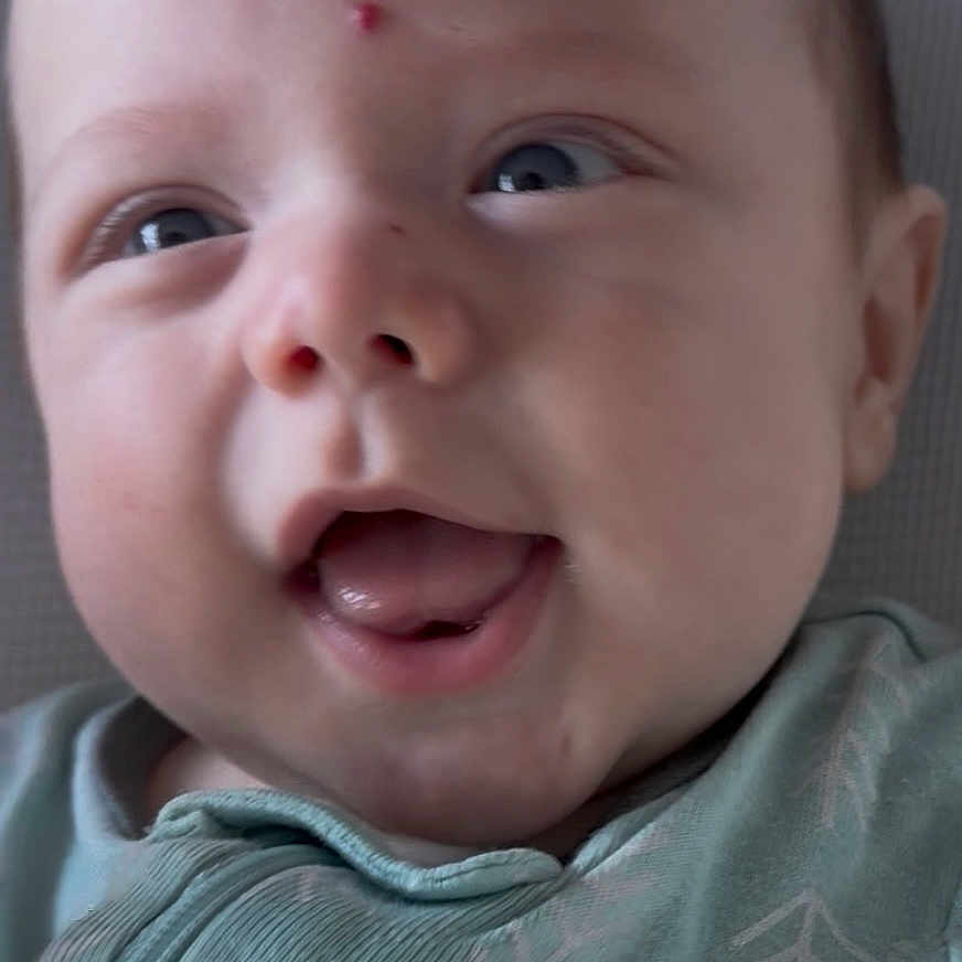 Donny joined the competition — help win amazing prizes! baby, blue_eyes, child, close_up, fabric, face, forehead, green_clothing, happy, head, infant, mark, mouth_open, onesie, pattern, portrait, skin, smiling, texture, tongue