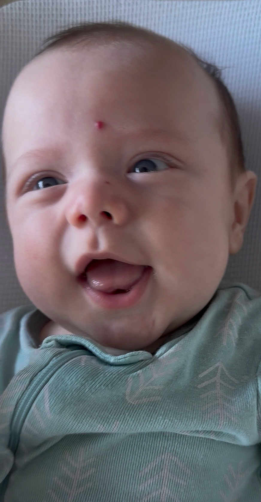 Donny joined the competition — help win amazing prizes! baby, close_up, face, happy, smiling, infant, child, blue_eyes, green_clothing, onesie, mouth_open, tongue, skin, head, forehead, mark, texture, fabric, pattern, portrait