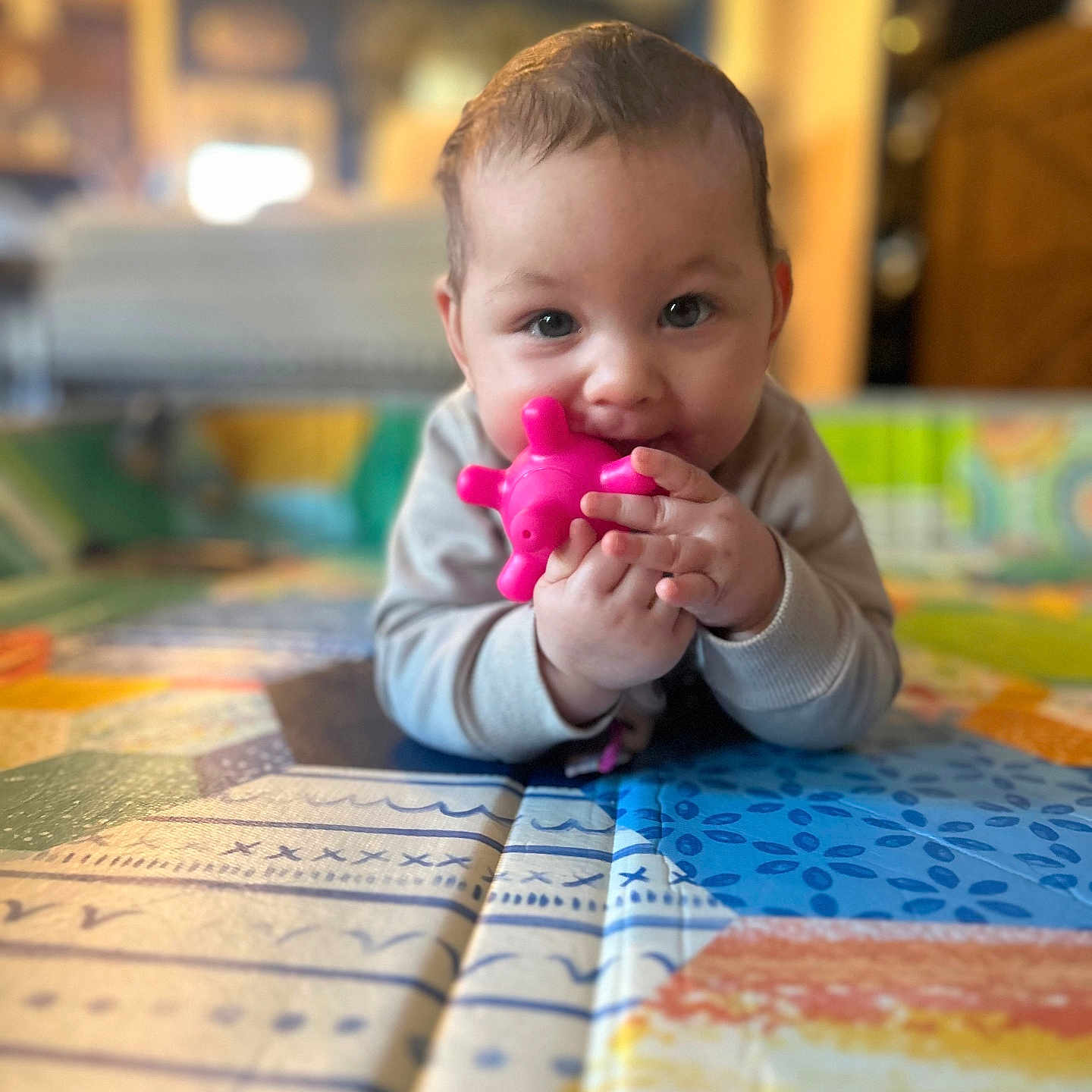 Kaleiah is registered to the contest to win money with this photo: baby, bodypart, cream, dessert, face, finger, food, furniture, hand, happy, head, icing, indoors, person, photography, portrait, quilt, sitting, smile, toy
