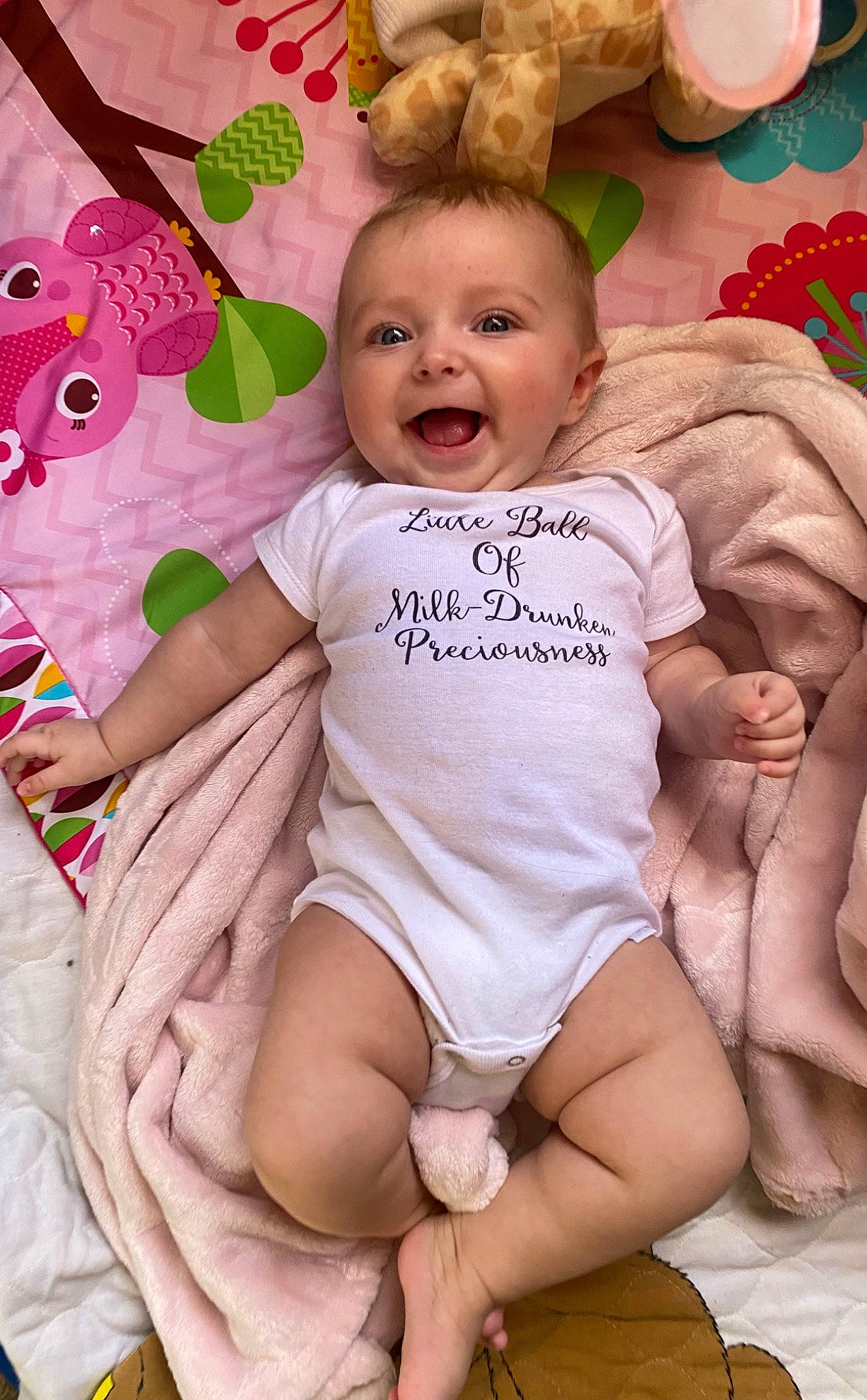 Alana joined the competition — help win amazing prizes! baby, baby_toddler_clothing, cheek, child, comfort, event, eye, fun, happy, head, human_body, human_leg, pattern, person, pink, sitting, skin, smile, textile, thigh