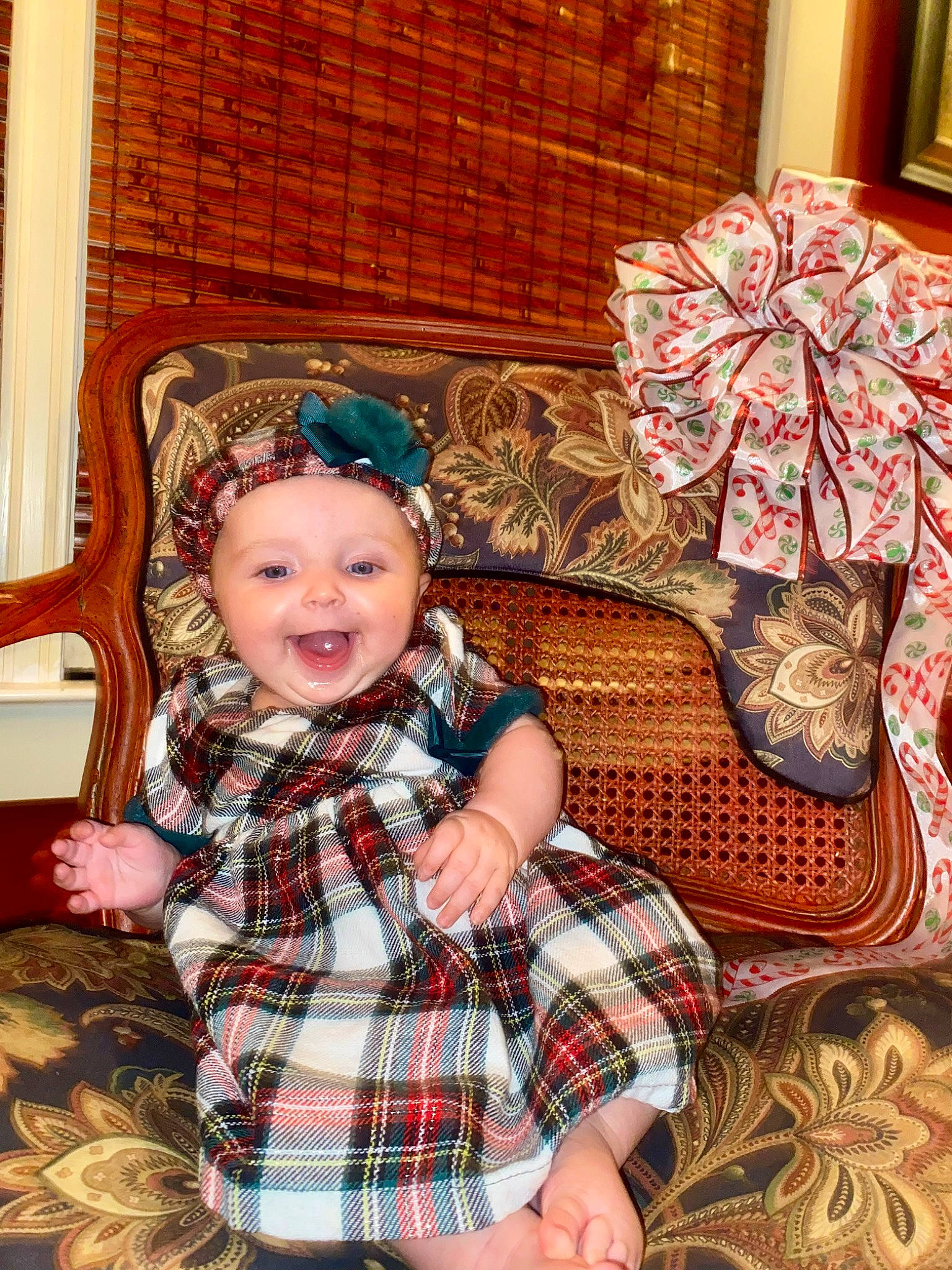 Alana is registered to the contest to win money with this photo: baby, baby_toddler_clothing, child, christmas, christmas_eve, comfort, dress, eye, head, headwear, pattern, person, plaid, sitting, sleeve, smile, tartan, textile, toddler, toy