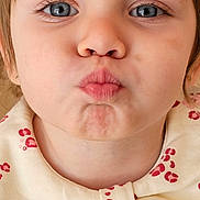 Miruna participe au concours pour gagner de l'argent avec cette photo : child, toddler, portrait, close_up, blue_eyes, pursed_lips, playful_expression, short_hair, earring, natural_skin, nose, mouth, eyelashes, bow_collar, patterned_clothing, indoor, soft_lighting, frontal_face, young_child, adorable