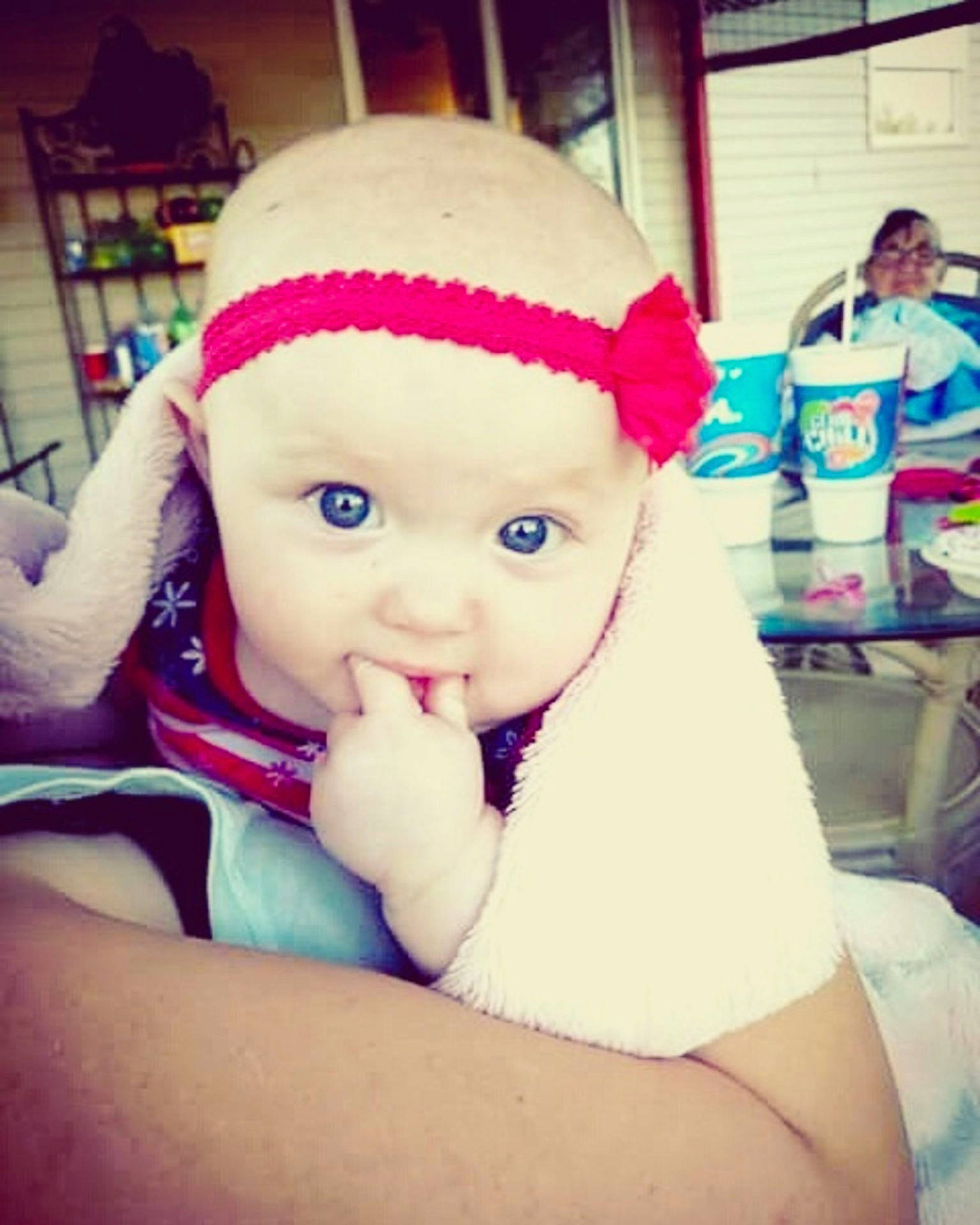 Eliana Ruth is registered to the contest to win money with this photo: cheek, child, cool, day, ear, eye, girl, hair_accessory, head, headgear, headwear, human_hair_color, infant, mouth, nose, organ, pink, product, skin, textile