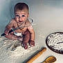 baby, child, clock_design, cute, diaper, face, floor, flour, foot, hands, indoor, kitchen_utensils, messy, necklace, playful, rolling_pin, sitting, whisk, wooden_board, wooden_spoon