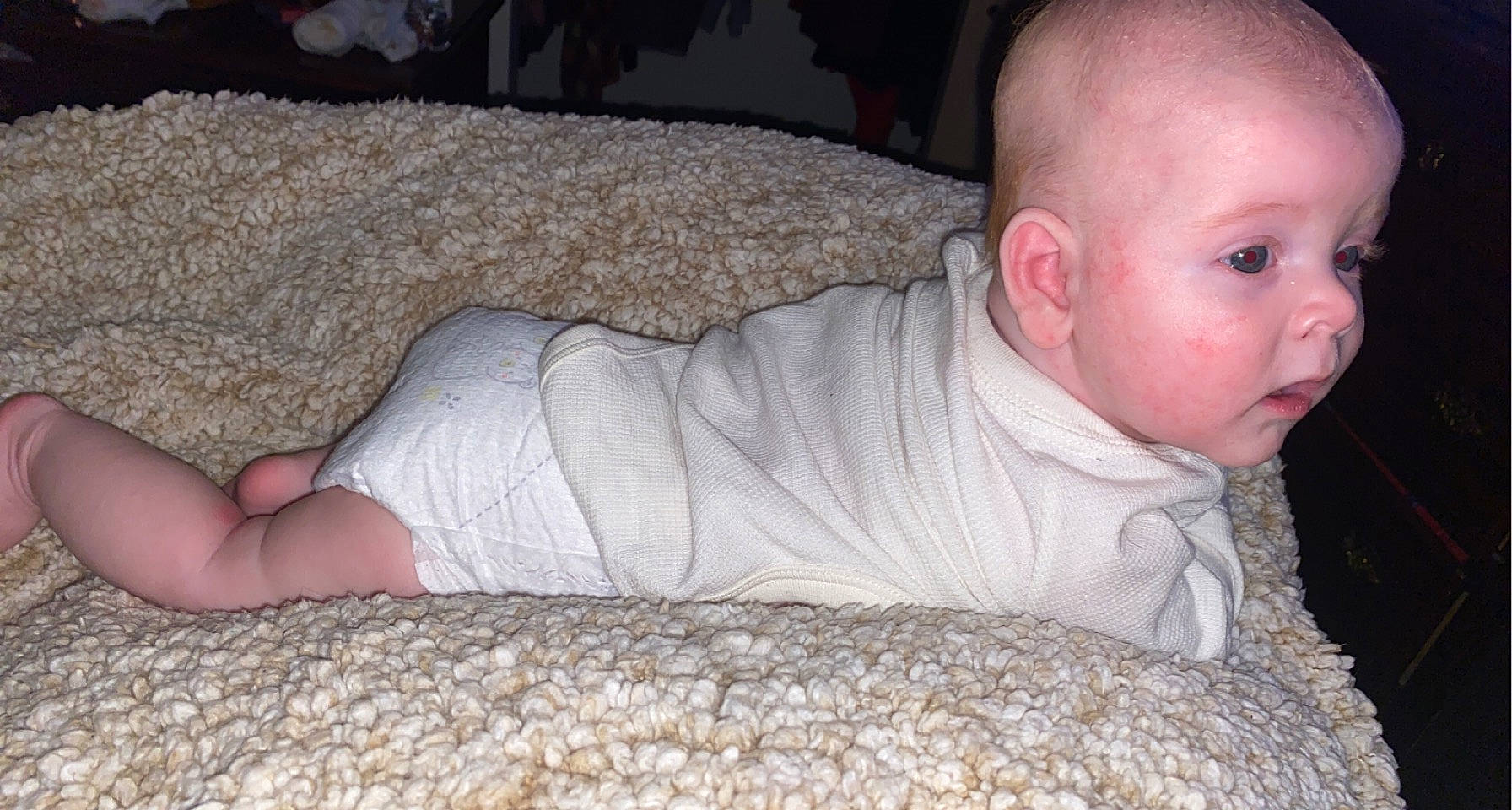 Andrew is registered to the contest to win money with this photo: baby, baby_toddler_clothing, comfort, crawling, elbow, floor, flooring, grass, grey, human_body, human_leg, knee, linens, mouth, person, skin, sleeve, thigh, toddler, tummy_time