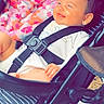 baby, stroller, blanket, child, smile, hair, seatbelt, clothing, outdoor, happy, infant, person, portrait, baby_carrier, graco, fabric, hand, head, sitting, cute