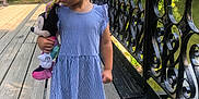 Kamara is registered to the contest to win money with this photo: child, girl, sunglasses, blue_dress, plush_toy, minnie_mouse, wooden_bridge, black_iron_railings, greenery, outdoor, summer, smiling, curly_hair, orange_shoes, walking, nature, sunlight, cute, person, portrait