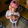 Callie is registered to the contest to win money with this photo: child, girl, pink_cap, beaded_necklace, bracelet, minnie_mouse_slippers, tshirt, indoor, tile_floor, wooden_table, chair, water_bottles, curious_expression, casual_clothing, accessories, cute, standing, looking_up, playful, home