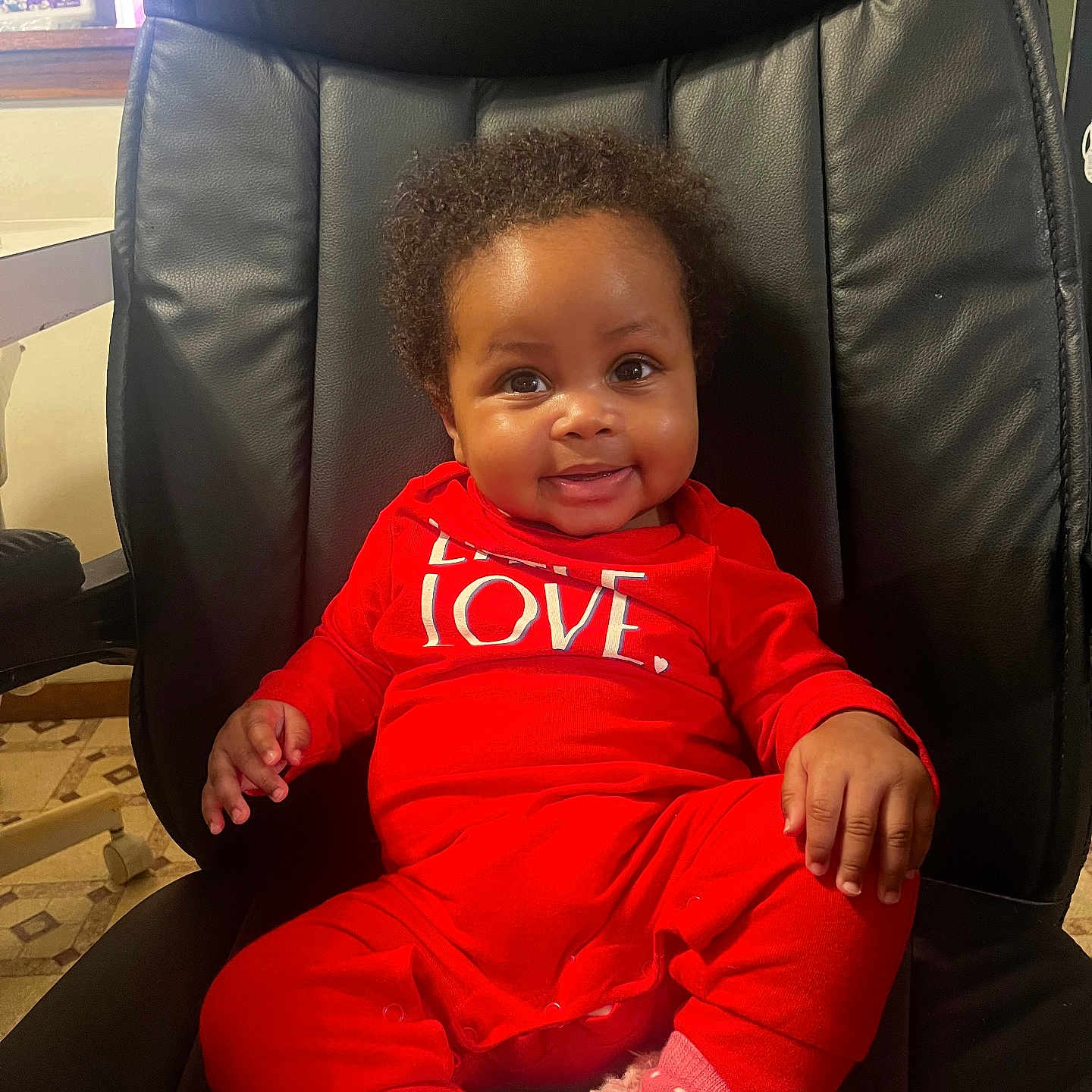 Zamaria is registered to the contest to win money with this photo: baby, chair, clothing, coat, couch, cushion, face, furniture, happy, head, homedecor, indoors, jacket, pants, person, photography, portrait, sitting, smile, t_shirt