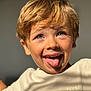child, boy, smiling, tongue_out, blond_hair, blue_eyes, close_up, portrait, casual_clothing, tshirt, sunlight, happy, playful, indoors, face, expression, young, skin, person, fun