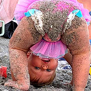 Ella joined the competition — help win amazing prizes! toddler, child, beach, sand, pink_tutu, upside_down, smiling, playful, happy, barefoot, person, summer, fun, cute, outdoor, family, baby, clothing, joy, sunlight