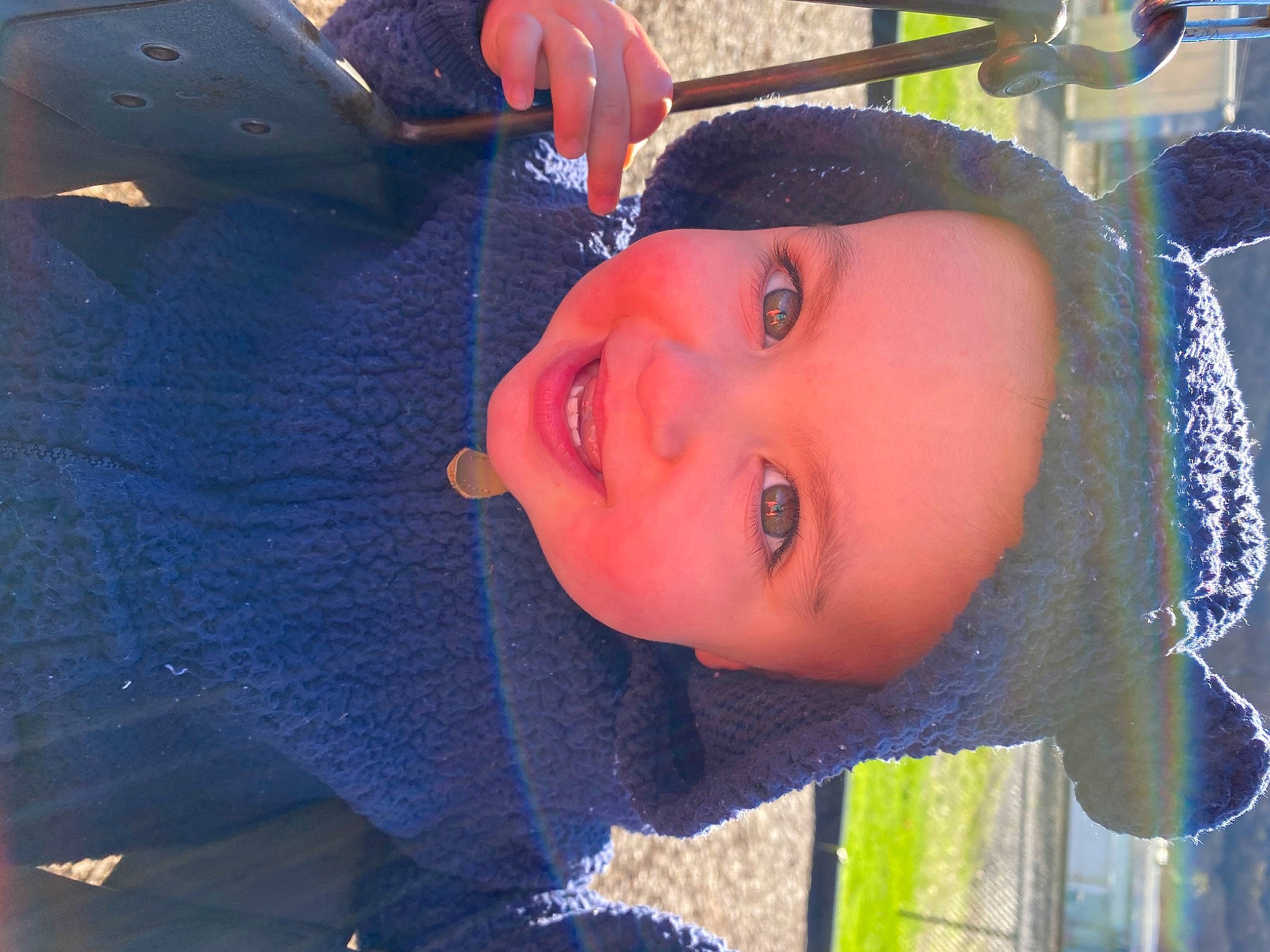 Everett is registered to the contest to win money with this photo: child, electric_blue, eyebrow, fun, grass, happy, hat, joy, landscape, leisure, lip, mouth, nose, outdoor_play_equipment, person, recreation, smile, sun_hat, toddler, tree