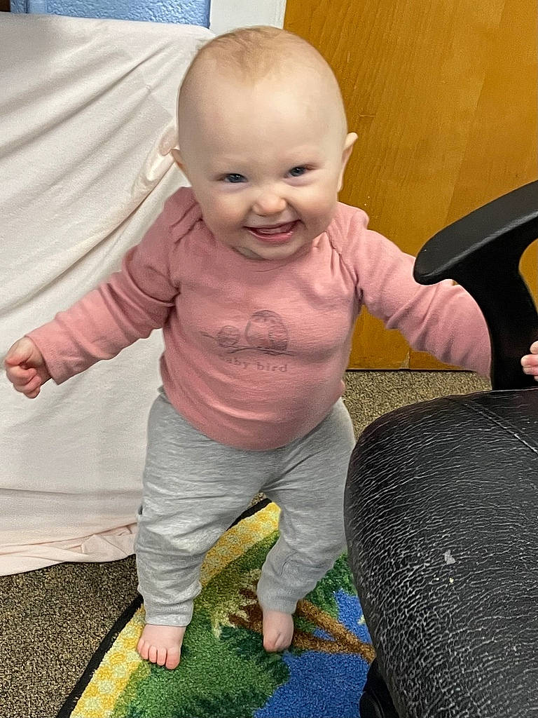 Lucy joined the competition — help win amazing prizes! baby, baby_products, baby_toddler_clothing, cheek, child, comfort, finger, floor, flooring, fun, gesture, grass, happy, human_body, joy, mouth, person, sitting, skin, smile