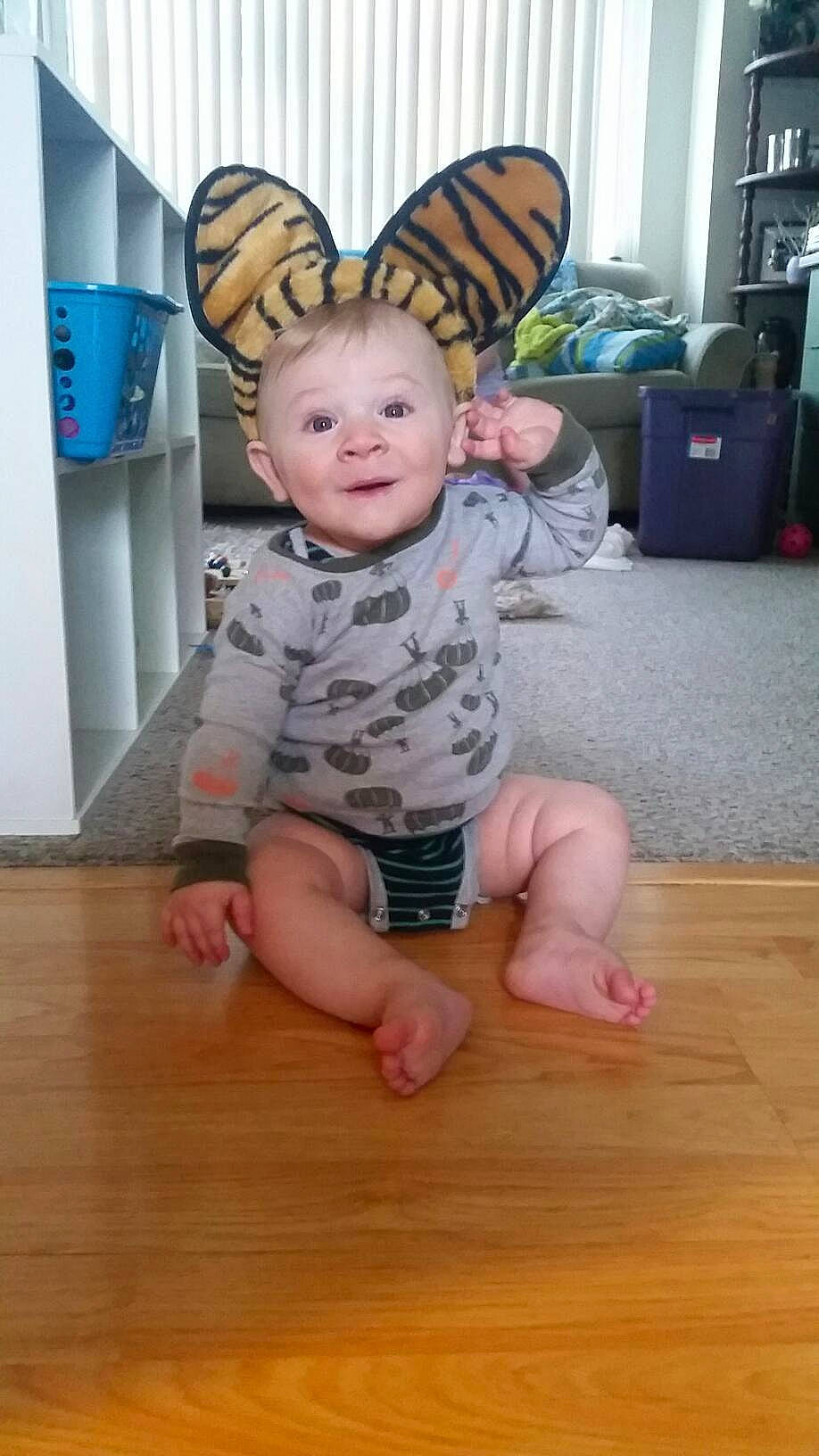 Knox is registered to the contest to win money with this photo: baby, baby_toddler_clothing, barefoot, facial_expression, floor, flooring, foot, fun, happy, hardwood, human_body, laminate_flooring, person, pink, skin, sleeve, smile, t_shirt, toddler, varnish