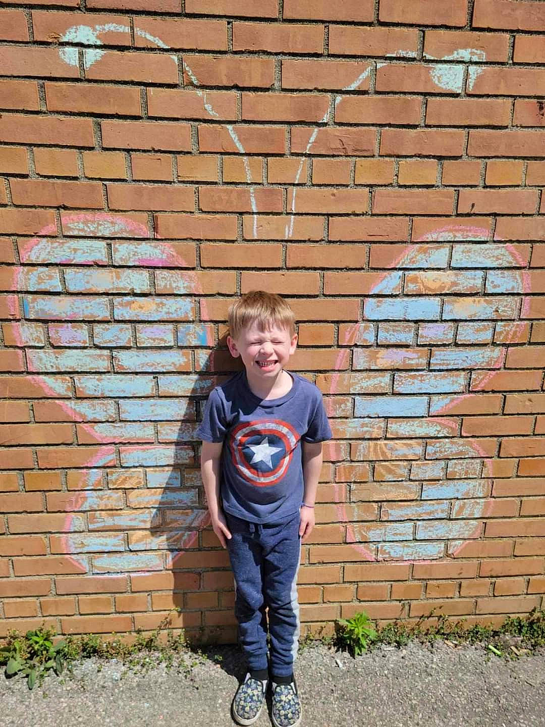 Knox is registered to the contest to win money with this photo: brick, brickwork, child, denim, electric_blue, fun, grass, happy, joy, landscape, people_in_nature, person, portrait_photography, recreation, smile, soil, stone_wall, t_shirt, toddler