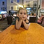 child, girl, table, outdoor, evening, cafe, people, building, chairs, wood, resting, contemplative, casual, dress, light, urban, social, relaxed, portrait, public