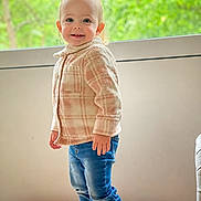 Skylar-Rose is registered to the contest to win money with this photo: toddler, child, standing, indoors, jeans, jacket, smiling, happy, window, greenery, face, footwear, casual_clothing, blond_hair, portrait, young_child, natural_light, cozy, cute, person