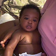 Mj is registered to the contest to win money with this photo: baby, diaper, infant, person, pink_shirt, blanket, indoors, skin, face, arm, leg, cuddling, comfort, child, young, cute, portrait, closeup, resting, calm