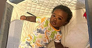 Mj joined the competition — help win amazing prizes! baby, blanket, carpet, child, comfort, curious, cute, dinosaur_pattern, home, indoor, infant, lying_down, pajamas, person, playpen, portrait, resting, sleepwear, soft_surface, young_child