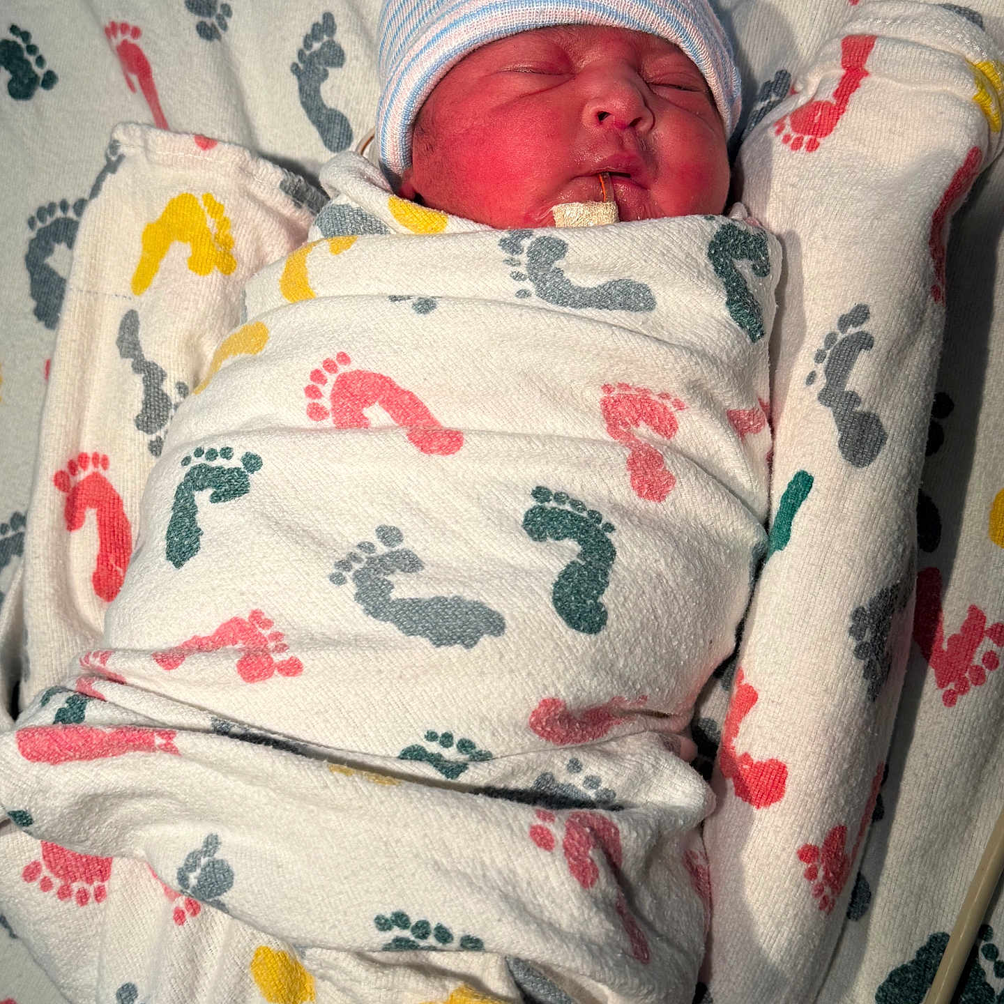 Prasmi is registered to the contest to win money with this photo: baby, blanket, child, cozy, cute, face, footprint_pattern, fresh, hat, hospital, indoors, infant, newborn, person, resting, sleeping, small, soft, swaddled, wrapped