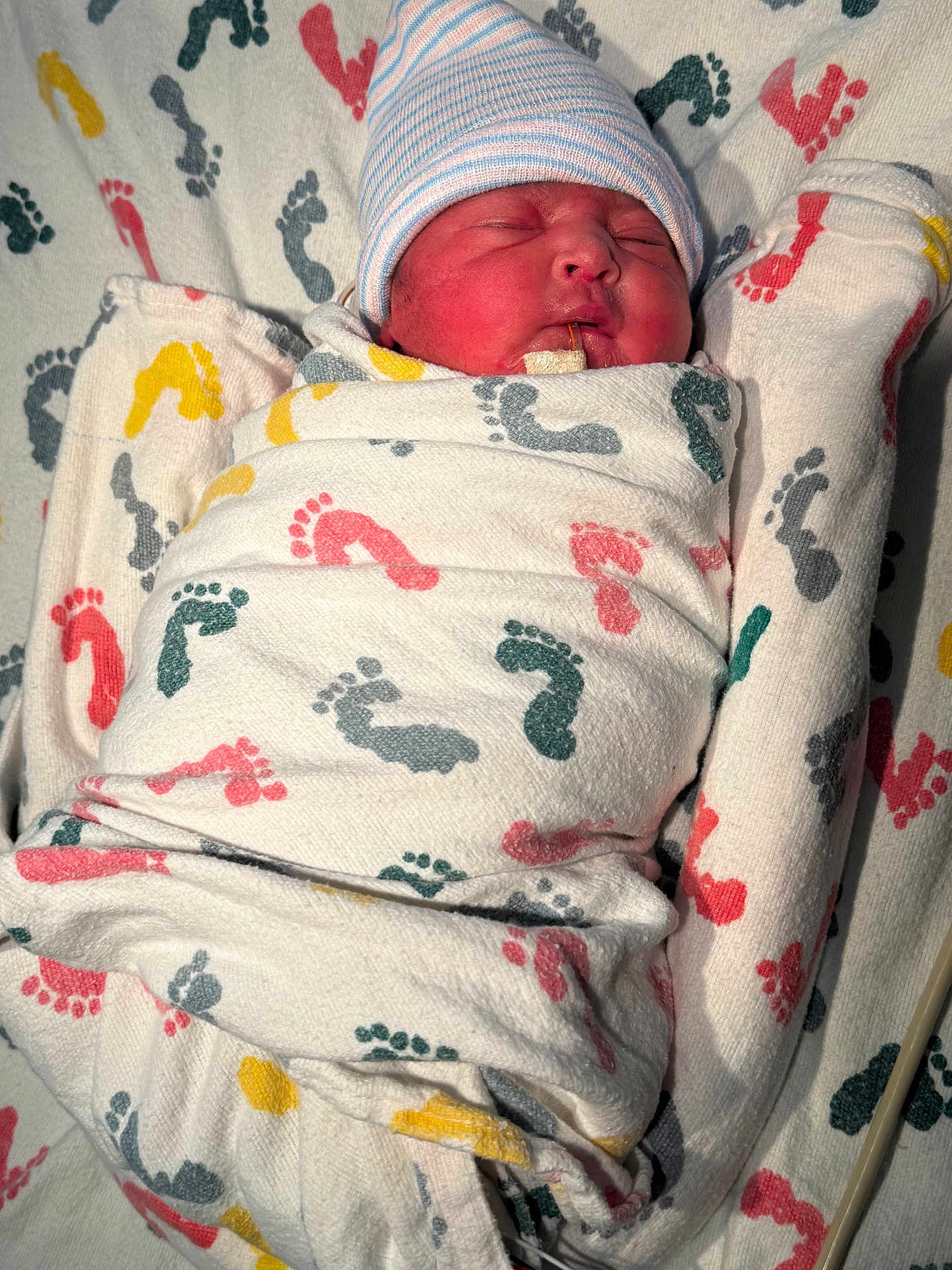 Prasmi is registered to the contest to win money with this photo: baby, blanket, child, cozy, cute, face, footprint_pattern, fresh, hat, hospital, indoors, infant, newborn, person, resting, sleeping, small, soft, swaddled, wrapped