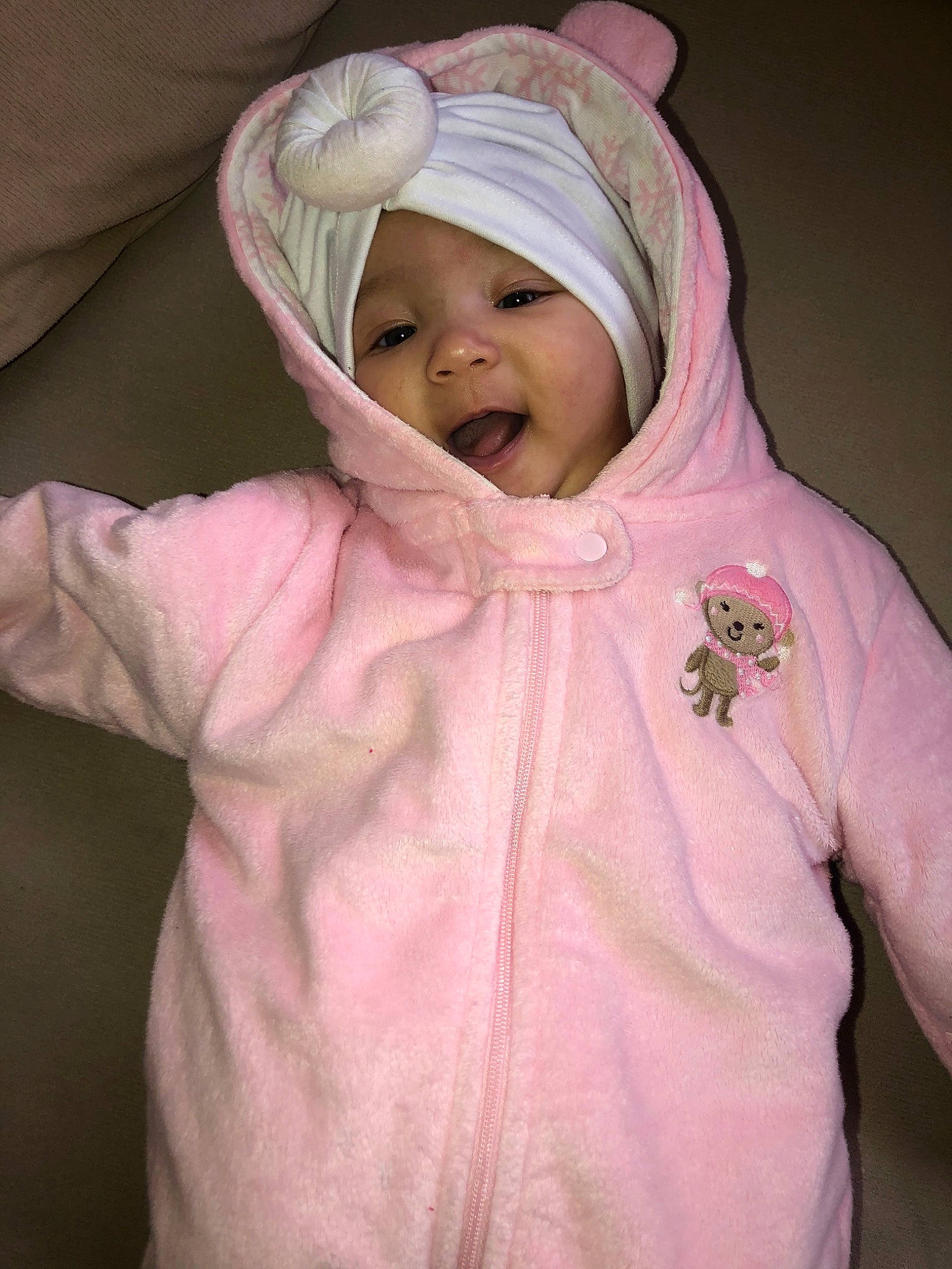 Yasmine is registered to the contest to win money with this photo: baby, cheek, child, headwear, hoodie, outerwear, person, pink, skin, smile, toddler