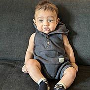 Tevis joined the competition — help win amazing prizes! baby, child, infant, portrait, sitting, couch, indoors, smiling, happy, face, eyes, hair, romper, clothing, socks, sunlight, curtains, home, photography, cute