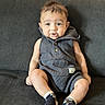 baby, child, infant, portrait, sitting, couch, indoors, smiling, happy, face, eyes, hair, romper, clothing, socks, sunlight, curtains, home, photography, cute