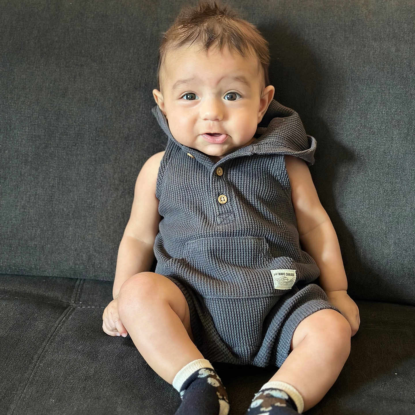 Tevis joined the competition — help win amazing prizes! baby, child, infant, portrait, sitting, couch, indoors, smiling, happy, face, eyes, hair, romper, clothing, socks, sunlight, curtains, home, photography, cute
