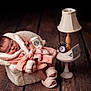 Ariella is registered to the contest to win money with this photo: baby, sleeping, pink_robe, slippers, starbucks_cup, miniature_laptop, alarm_clock, table_lamp, small_chair, cozy, indoor, napping, cute, furniture, wood_floor, soft_texture, portrait, child, resting, funny