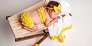 Ariella joined the competition — help win amazing prizes! baby, sleeping, yellow_clothing, headband, wooden_hammock, white_towel, polka_dot, toy, popsicle, colorful, beach_ball, summer, infant, cute, studio, child, relaxing, soft_lighting, portrait, indoor