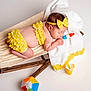 baby, sleeping, yellow_clothing, headband, wooden_hammock, white_towel, polka_dot, toy, popsicle, colorful, beach_ball, summer, infant, cute, studio, child, relaxing, soft_lighting, portrait, indoor