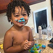 Dior joined the competition — help win amazing prizes! bakery, baking, blue_frosting, child, countertop, cupcakes, curly_hair, diaper, face, food, fun, happy, indoor, kitchen, messy, person, playful, smiling, sweet, toddler