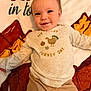 Walker Lee is registered to the contest to win money with this photo: baby, child, smiling, shirt, turkey, thanksgiving, blanket, cozy, cute, happy, infant, clothing, laying_down, portrait, face, holiday, cuddle, warm, pants, young