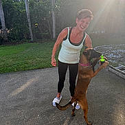 Akina joined the competition — help win amazing prizes! bottle, casual_clothing, collar, dog, fence, grass, leggings, nature, outdoor, pavement, pet, playful, shadow, shoes, smiling, sunflare, sunlight, tank_top, trees, woman