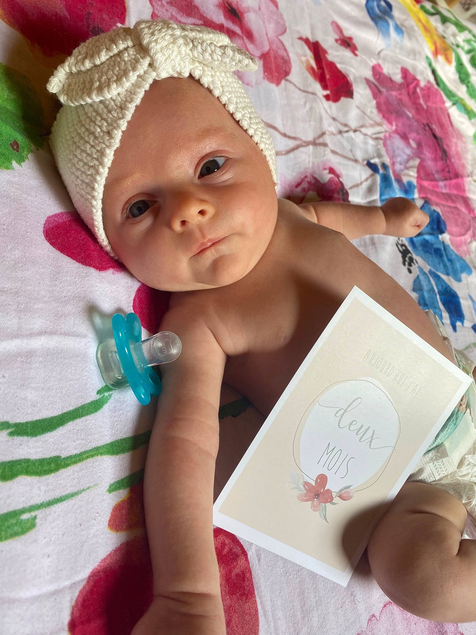 Lizzie a rejoint le concours — aidez-le/la à gagner de superbes lots ! baby, baby_products, baby_safety, baby_toddler_clothing, cap, cheek, child, comfort, fashion_accessory, happy, headgear, headwear, linens, nail, person, pink, product, room, skin, textile