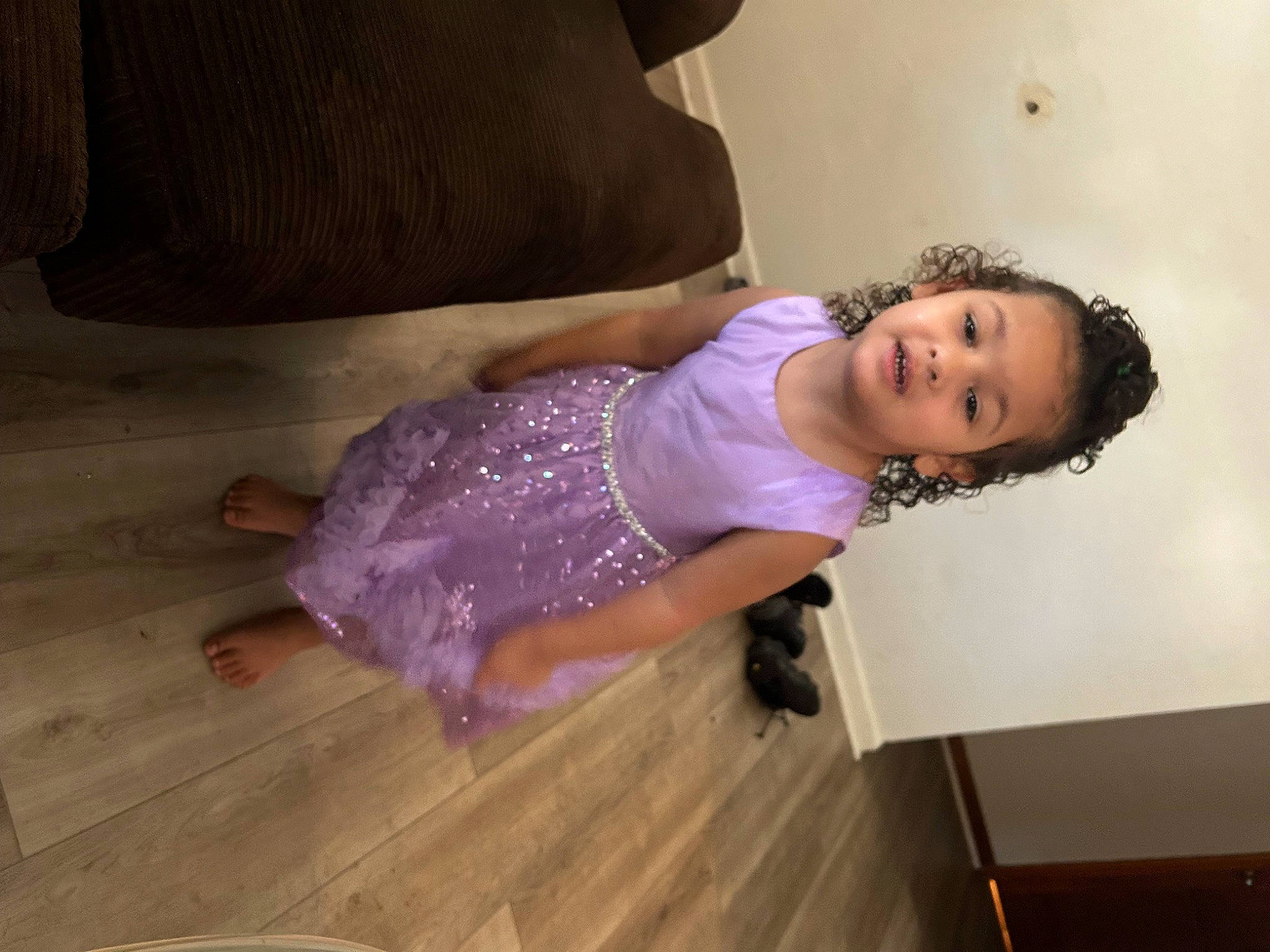 Izabelle is registered to the contest to win money with this photo: arm, baby_toddler_clothing, cheek, child, comfort, dress, floor, flooring, happy, hardwood, human_leg, leg, person, purple, skin, sleeve, smile, thigh, toddler, trunk
