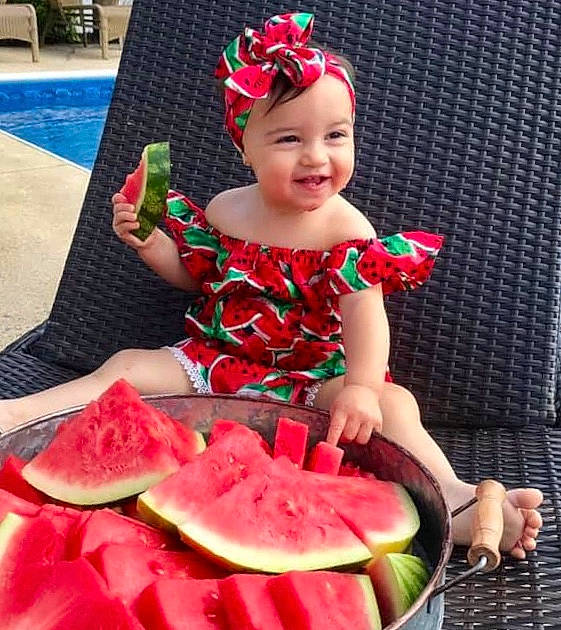 Bianca is registered to the contest to win money with this photo: _and_melon_family, _gourd, baby, child, citrullus, costume, cucumber, eating, food, fruit, melon, person, plant, produce, sitting, smile, toddler, watermelon
